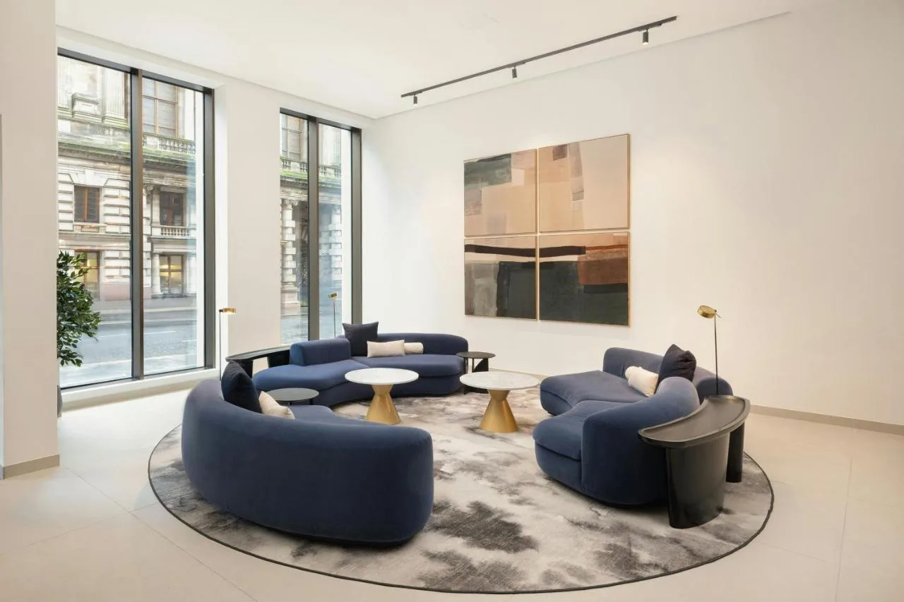Blue couches and rug in a lounge area at AC Hotel Glasgow