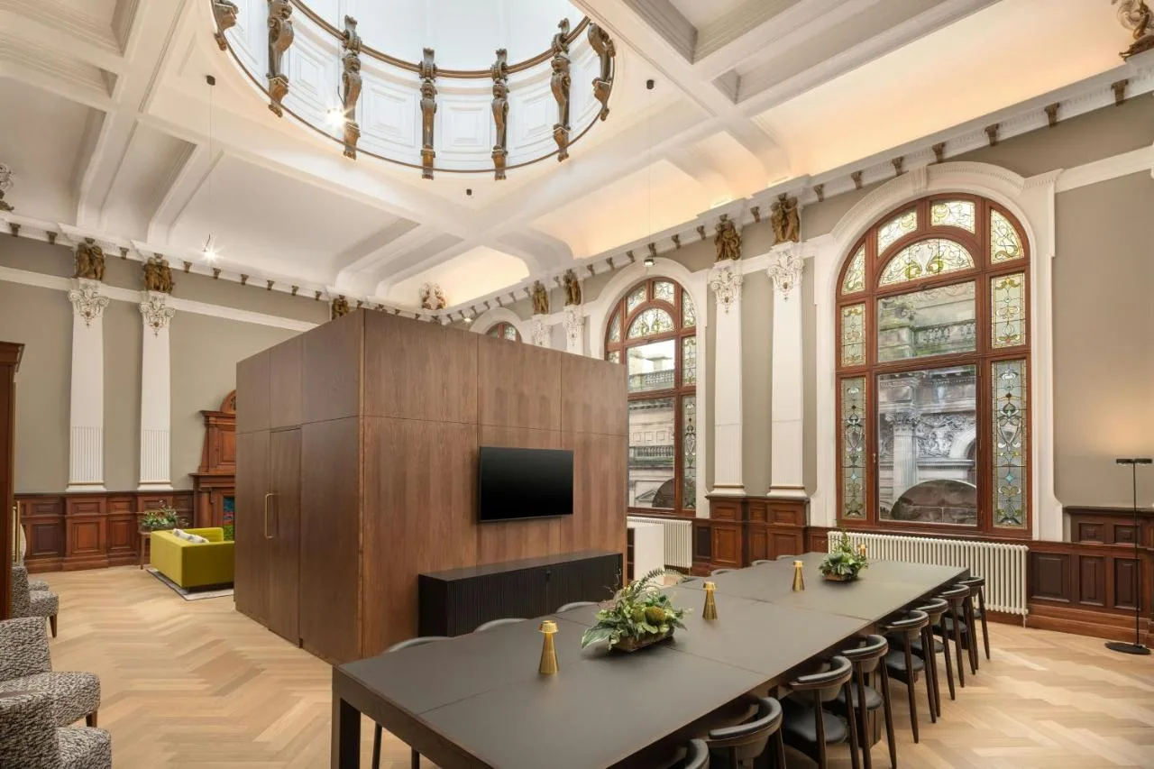Tables and chairs in a bright meeting room at AC Hotel Glasgow
