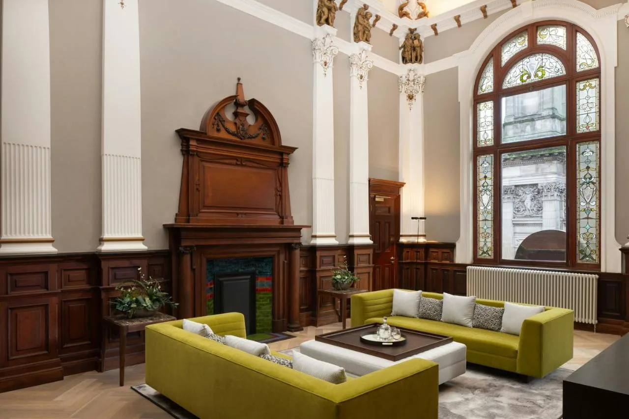 Couches beside a fireplace in the lounge at AC Hotel Glasgow